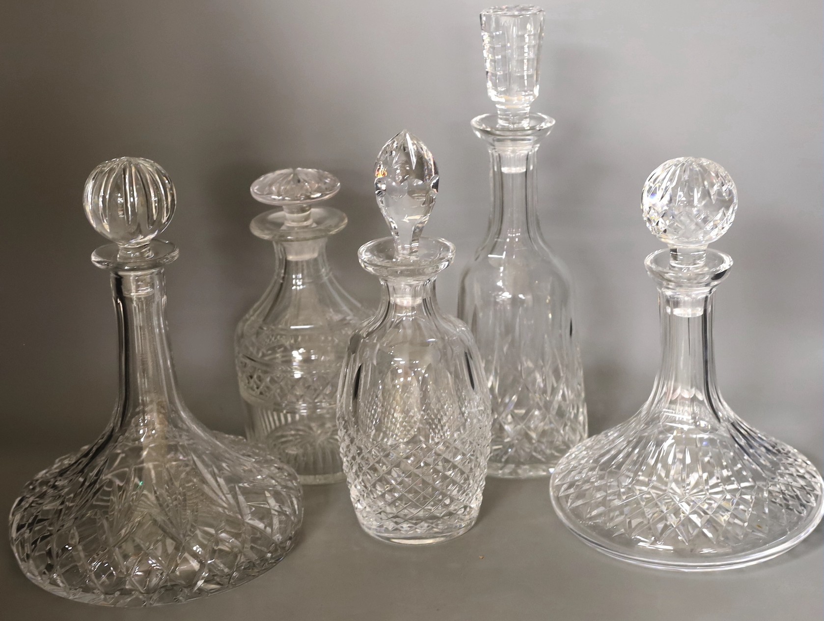Two Waterford glass decanters, and three other decanters